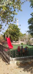 a park with a playground with a swing at The Holiday Farm in Barka
