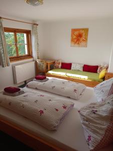 a bedroom with two beds and a couch at Pferdehof Oberegg in Werfenweng