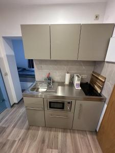a small kitchen with a sink and a stove at Appartement Wolfshagen in Elbingerode +4 photos