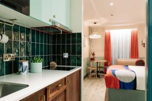 a kitchen with a sink and a bedroom with a bed at room2 Belfast Hometel in Belfast