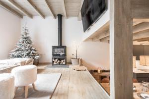 a living room with a christmas tree and a fireplace at Casa Baqueira in Betrén