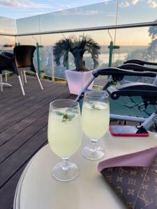 two glasses of white wine sitting on a table at Boutique Hotel MaMa in Jūrmala