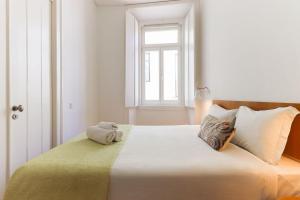 a bedroom with a bed with two towels on it at Alfama Deluxe by Homing in Lisbon