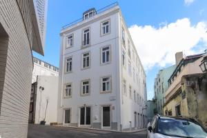 a white building on the side of a street at Alfama Deluxe by Homing in Lisbon