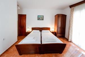 a bedroom with a large bed with white sheets at Villa MD in Budva