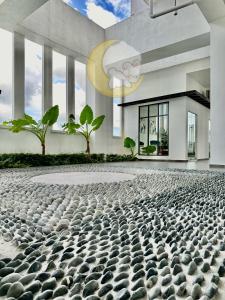a building with a large number of rocks on the ground at NEW Cozy Menjalara 5mins to DesaParkCity 2Rooms in Kuala Lumpur
