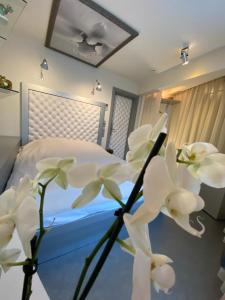 a bedroom with a bed with white flowers at Boutique Hotel Mama in Jūrmala