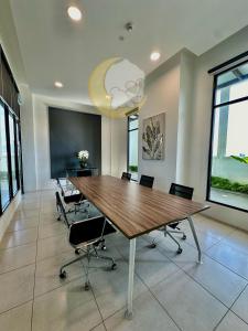 a conference room with a large wooden table and chairs at NEW Cozy Menjalara 5mins to DesaParkCity 2Rooms in Kuala Lumpur