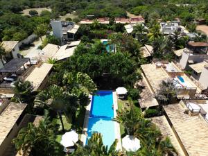 an aerial view of a resort pool with palm trees at Casa Pipa Beleza in Pipa