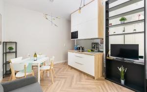 a kitchen and dining room with a table and a kitchen and a living room at Rent like home - Kujawska 3 in Warsaw