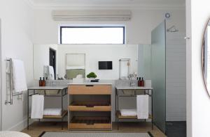 a bathroom with a sink and a mirror at Twice Central Guest House in Stellenbosch