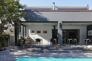 an external view of a house with a swimming pool at Twice Central Guest House in Stellenbosch