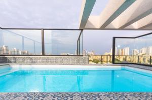 a swimming pool on the roof of a building at Luxurious penthouse for couples in Kiryat Mozkin in Qiryat Motzkin