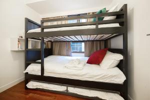 a bedroom with a bunk bed with white sheets at Tsim ShaTsui Luxury 3bedroom Apartment near MTR！ in Hong Kong