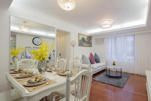 a dining room and living room with a table and chairs at Tsim ShaTsui Luxury 3bedroom Apartment near MTR！ in Hong Kong