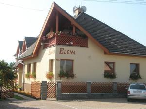 a building with a balcony on the side of it at Villa Elena in Smižany