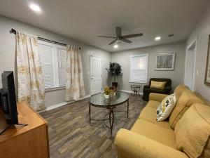 a living room with a couch and a table at Charming City Bungalow in Jacksonville