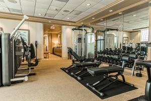 a gym with treadmills and machines in a room at King Luis - B in Galveston