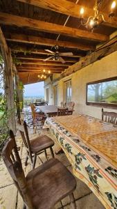 a dining room with tables and chairs and a ceiling at Holiday Country Villa with Panoramic Views in Bouteilles-Saint-Sébastien