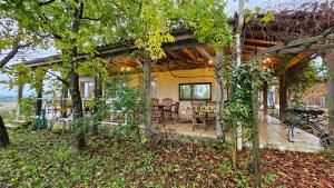 a house with a covered porch with a table and chairs at Holiday Country Villa with Panoramic Views in Bouteilles-Saint-Sébastien