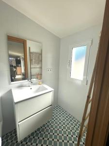 a white bathroom with a sink and a mirror at Lalola villas - Casa privada Denia in Denia