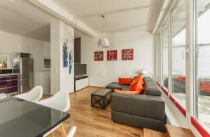 a living room with a couch and a table at Appartements Tamino by Schladming-Appartements in Schladming