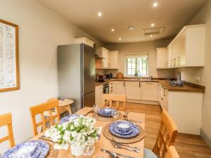 a kitchen and dining room with a table and chairs at Upper Lodge in Bowness-on-Windermere