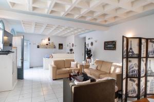 a living room with white walls and a coffered ceiling at Hotel Selini in Agios Nikitas