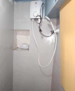 a shower with a hose attached to a wall at De Hagan Transient Baguio City in Baguio +146 photos