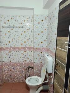 a bathroom with a toilet and a shower at HOTEL ATITHI GRAND in Guwahati