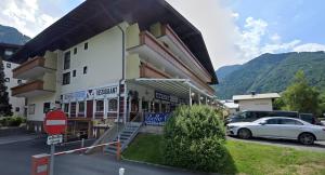 a white car parked in front of a building at Kaprun Mountain Studio with Summer CARD- Central Location in Kaprun