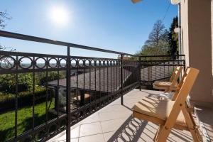 a balcony with a chair and a railing at 1-Bedroom Apartment with Balcony in Ledine