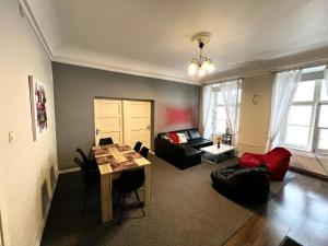 a living room with a couch and a table at Large Vacation Apartments in the Old Town in Riga