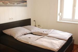 a bed with white pillows on it in a room at Ferienwohnung Ratisbona in Regensburg