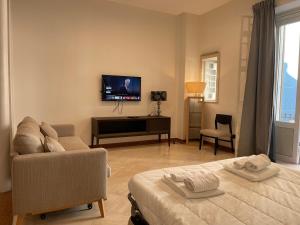 a living room with a bed and a tv at Putignani Exclusive Suite in Bari
