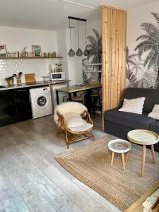 a living room with a couch and a table at L’appart Duplex Bis in Le Havre