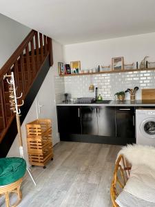 a kitchen with a sink and a washing machine at L’appart Duplex Bis in Le Havre