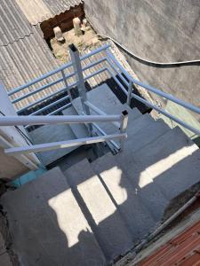 an overhead view of a staircase with a metal railing at Kitnets da Tia Zeni in Arraial do Cabo
