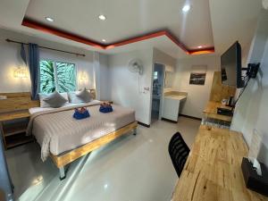 a bedroom with a bed with two dolls on it at CheeVa Beach Resort in Ban Tai +30 photos