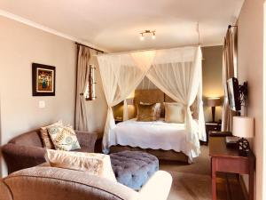 a bedroom with a canopy bed and a couch at Dunstone Estate in Wellington