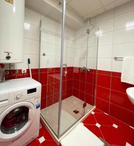a red and white bathroom with a washing machine at SNEZANA APARTMENT in Ohrid +29 photos