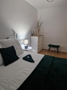 Un dormitorio con una cama con un sombrero negro. en Apartament Mar&Mel en Głuchołazy