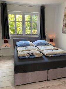 Ένα ή περισσότερα κρεβάτια σε δωμάτιο στο Ferienhof Kolauerhof - Bauernhofurlaub in Grömitz +121 φωτογραφίες