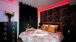 a bedroom with a bed with a red light on it at Le Sainte Croix Hyper Centre Metz in Metz