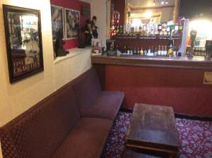 a bar with a bench and a table in a room at The Aberford in Blackpool
