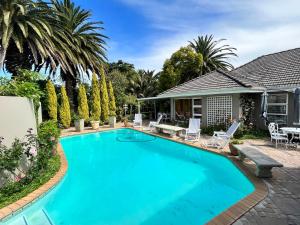 a swimming pool in front of a house at Somerset West Garden Apartments 2 in Somerset West