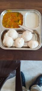 a plastic container with food and a bowl of soup at Hotel aasra guest house in Bharwain