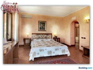 a bedroom with a large bed in a room at Antica Filanda in Capri Leone