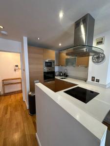 a kitchen with a white counter top and a stove at Two BR Flat 5 mins walk from London eye G96 in London