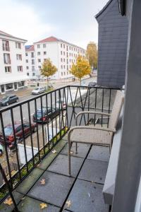 einen Balkon mit einer Bank und einem Parkplatz in der Unterkunft Volante Apartment Bremen-Findorff in Bremen